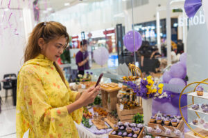 a lady is taking photo of the dessert table