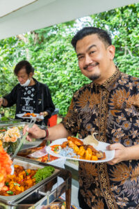 Guests happily choosing malay cuisines at buffet catering for malay weddingÂ