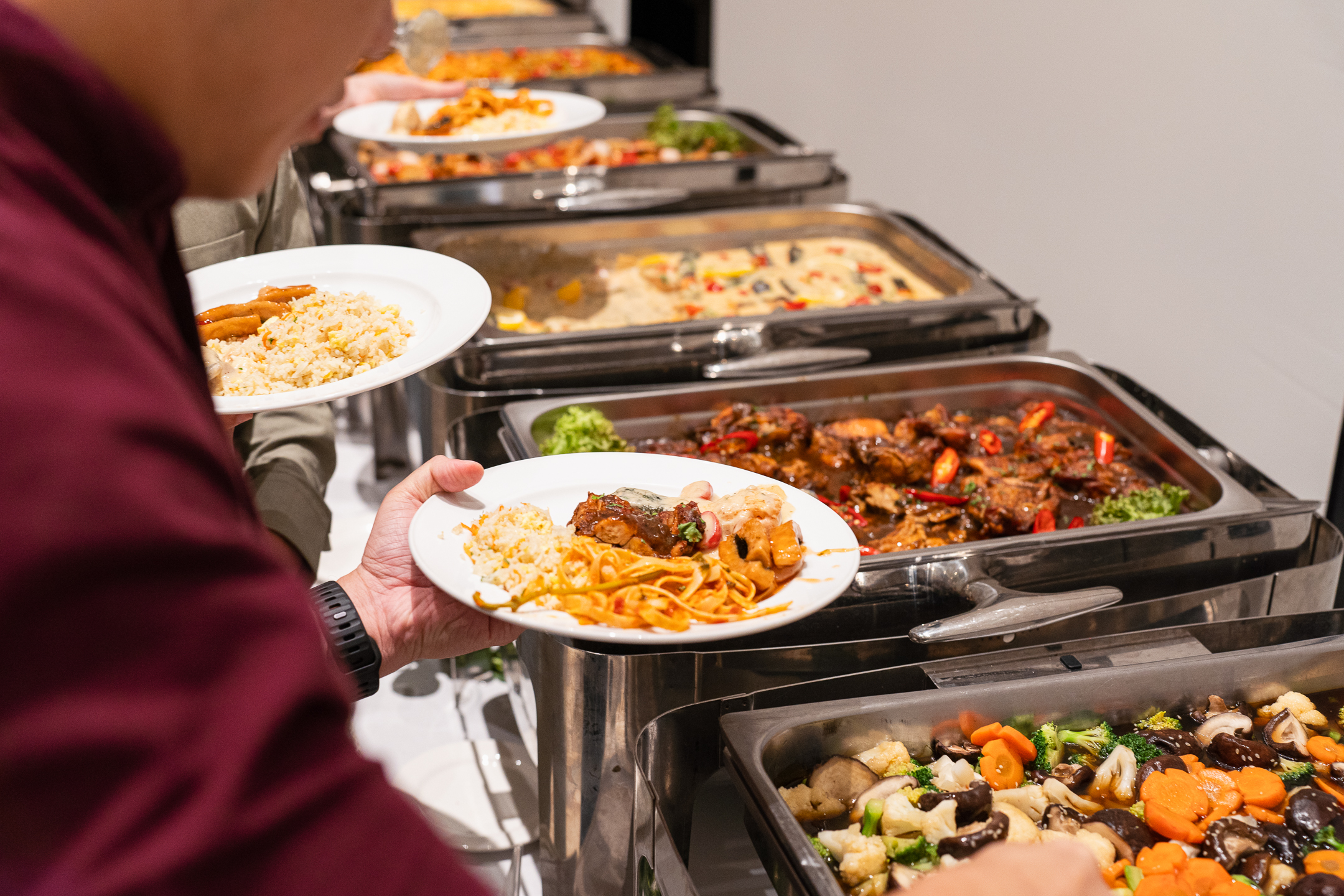 Event catering by iDoCatering with a variety of cuisines served on elegant trays for a wedding