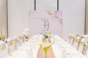 Elegant and sophisticated white floral wedding table and backdrop setup by iDoCatering