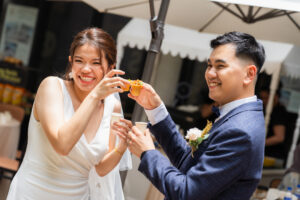 Bride and groom smiling towards the camera during a wedding catering event at CyberjayaÂ